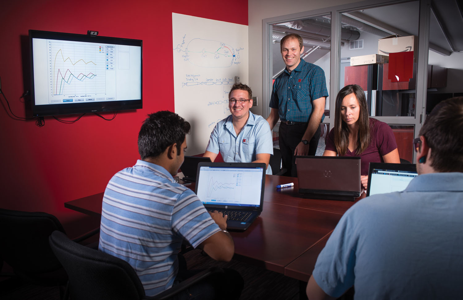 Tomas Helikar and Joe Dauer (center) with postdocs Heather Bergan-Roller, Bhanwar Lal Puniya and student worker Greyson Biegert