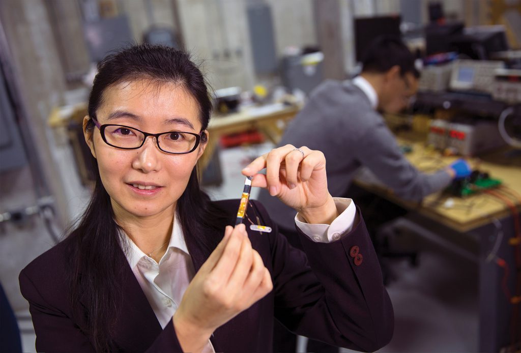 Liyan Qu holds a prototype of a device that could help revolutionize the power grid. Qu is UNL's newest NSF CAREER award. February 12, 2016. Photo by Craig Chandler / University Communications
