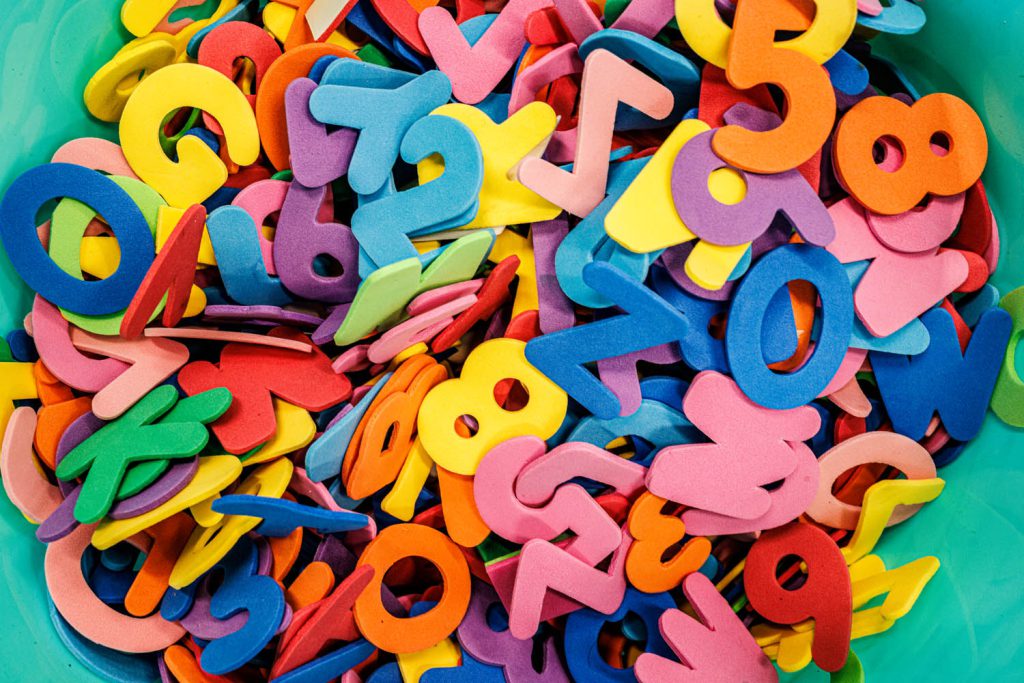 colorful foam numbers and letter in a pile 