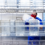 Jeffrey Price loading cages at Gnotobiotic Mouse Facility