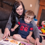 young woman with preschooler looking at book