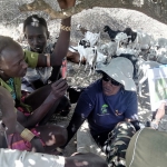 Rahab Kinyanjui shows images of plant species to young herders