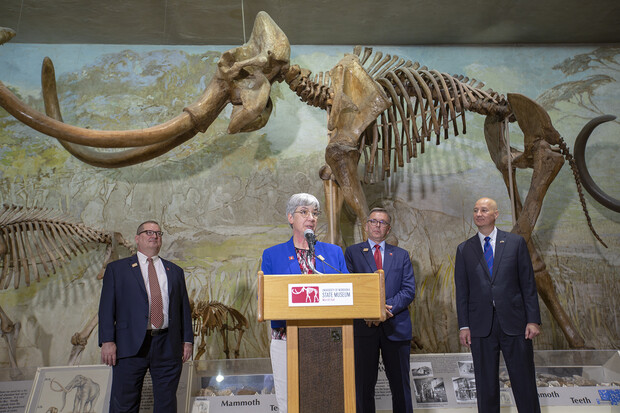 Susan Weller speaking at Morrill Hall with Bob Wilhelm, Ronnie Green and Pete Ricketts behind her
