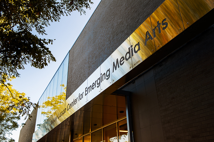 A photo looking up at the front of the building showing the name of the Johnny Carson Center for Emerging Media Arts.
