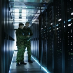 military members working in open server rack