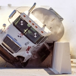 tractor-tanker vehicle slamming into roadside barrier