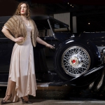 Anna Kuhlman wearing 1930s style gown next to 1930 Duesenberg Model J