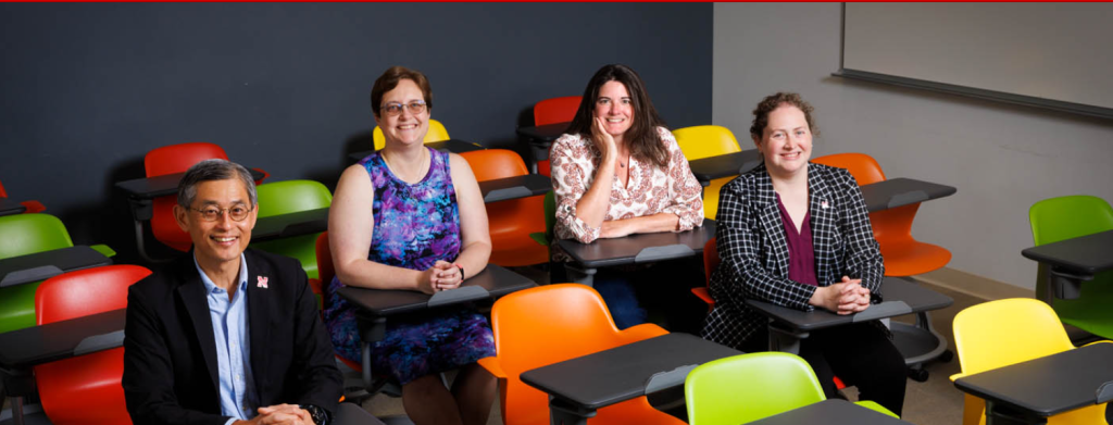 Photo of researchers sitting in colorful classroom chairs.