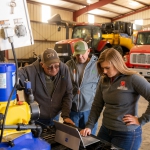 Taylor Cross speaks to ag producers Doug and Tony Jones