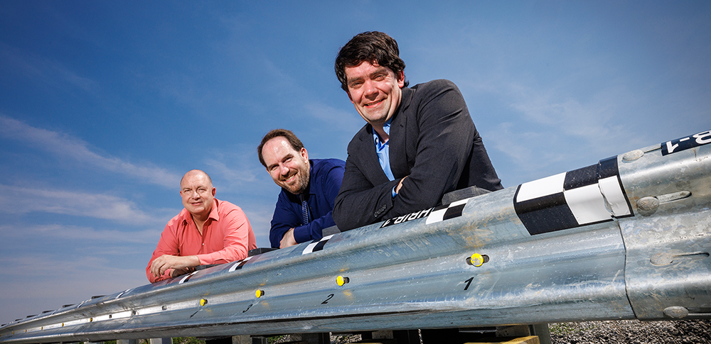 three faculty members posing with guardrail