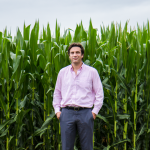 Patricio Grassini in front of corn field