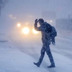 man walking in blizzard