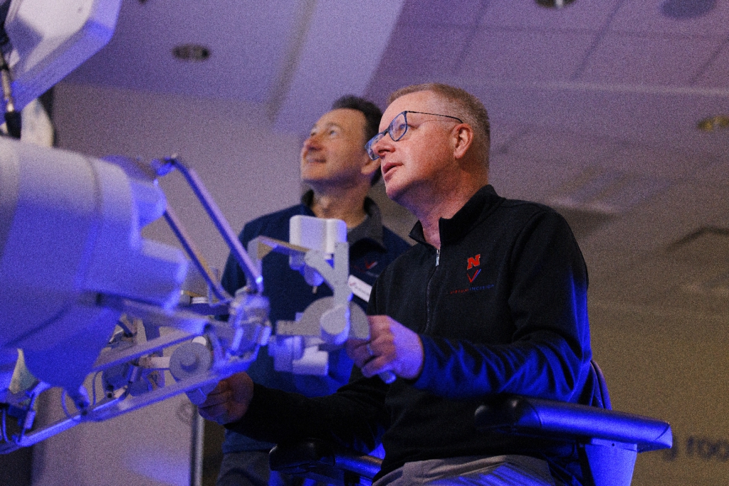 Shane Farritor uses surgical robot as Dr. Dmitry Oleynikov looks on