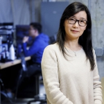 Woman standing in front of an engineering lab.