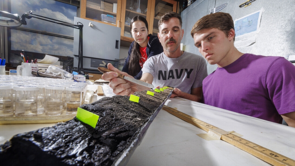 Doctoral student Jim Benes and UCARE students Jasmine Pham and Joe Stalder in lab