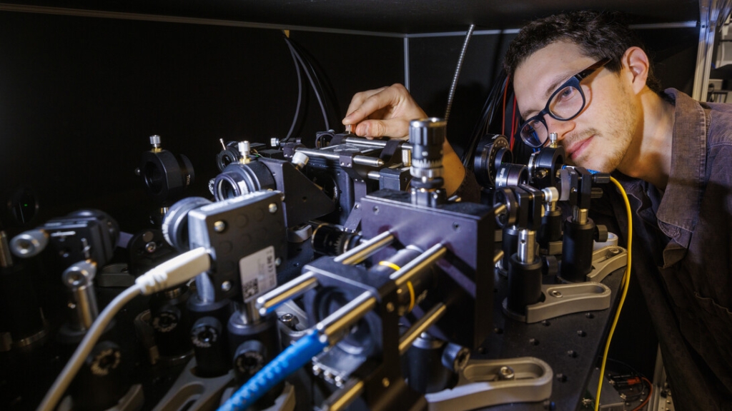 Adam Erickson adjusts the nitrogen-vacancy scanning probe in Abdelghani Laraoui's lab.