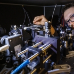 Adam Erickson adjusts the nitrogen-vacancy scanning probe in Abdelghani Laraoui's lab.