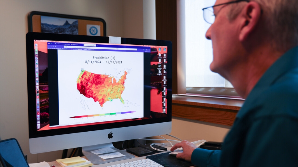 William Sorensen, , senior applications/systems programmer for the High Plains Regional Climate Center, reviews an Applied Climate Information System map