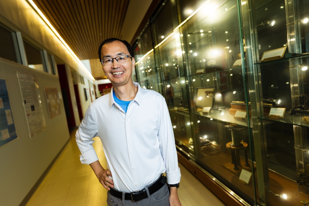 Image of Xaioshaun Xu standing in the hallway of his lab.