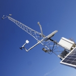 A tall metal tower stretches into the sky, complete with a solar panel.