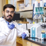 Prabhashis Bose, a food science and technology doctoral student, runs an experiment using a Titrando machine that mimics the semi-dynamic state of human digestion in his lab inside the Food Innovation Center on Innovation Campus.